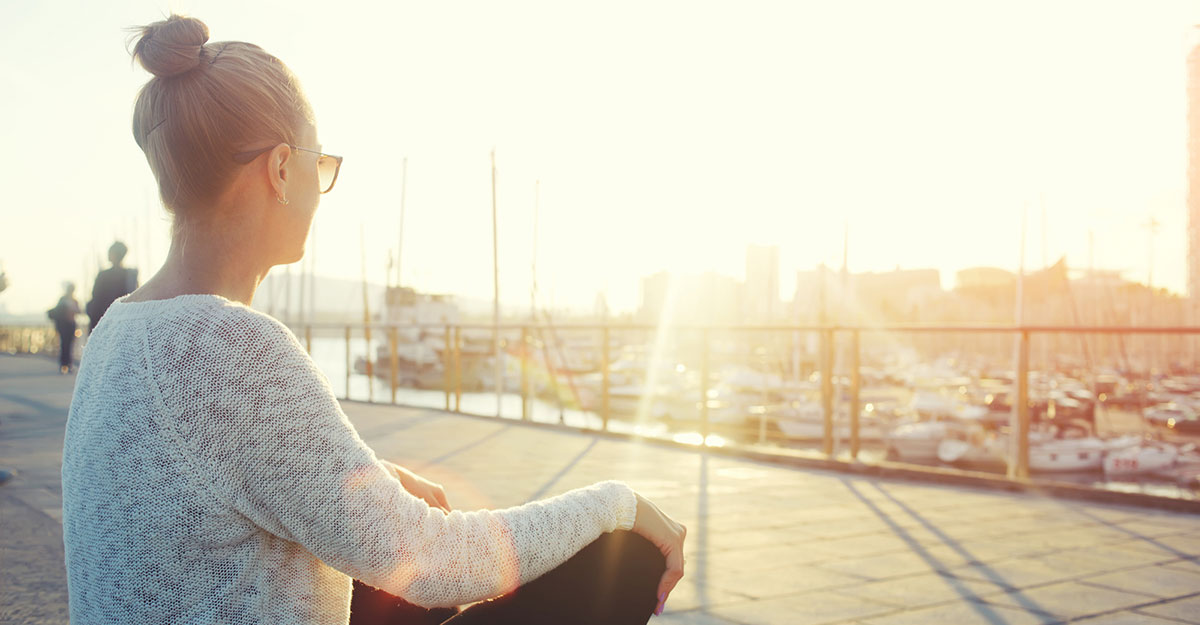 Woman looking into the sun after a session of cancer counseling near Tampa, FL with Sheltering Oaks Counseling. You can get help with online therapy in Florida for cancer counseling based in Wesley Chapel, FL too.