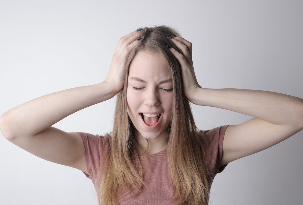 Millennial woman looking frustrated and screaming needs young adult counseling near Tampa, FL. Sheltering oaks provides therapy for young adults in Wesley Chapel, FL. You can get help with online therapy in Florida for millennials here!