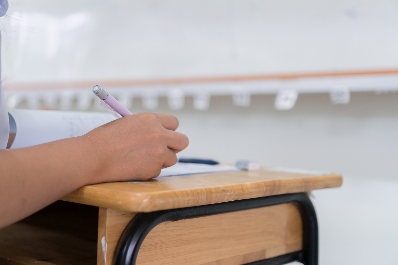 A young hand holds a pencil as they write something on the test in front of them. This could represent the benefits of neuropsychological testing in Tampa, FL. Your child can thrive academically with the help of neuropsych testing in Wesley Chapel, FL. Learn more!